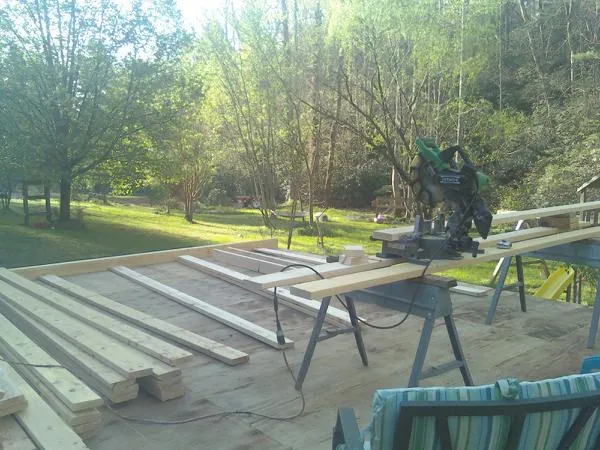 Miter saw and framing lumber on a deck under construction in Bethlehem